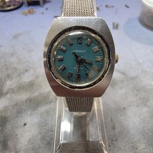 vintage Caravelle by Bulova women's watch with an emerald green dial and a silve